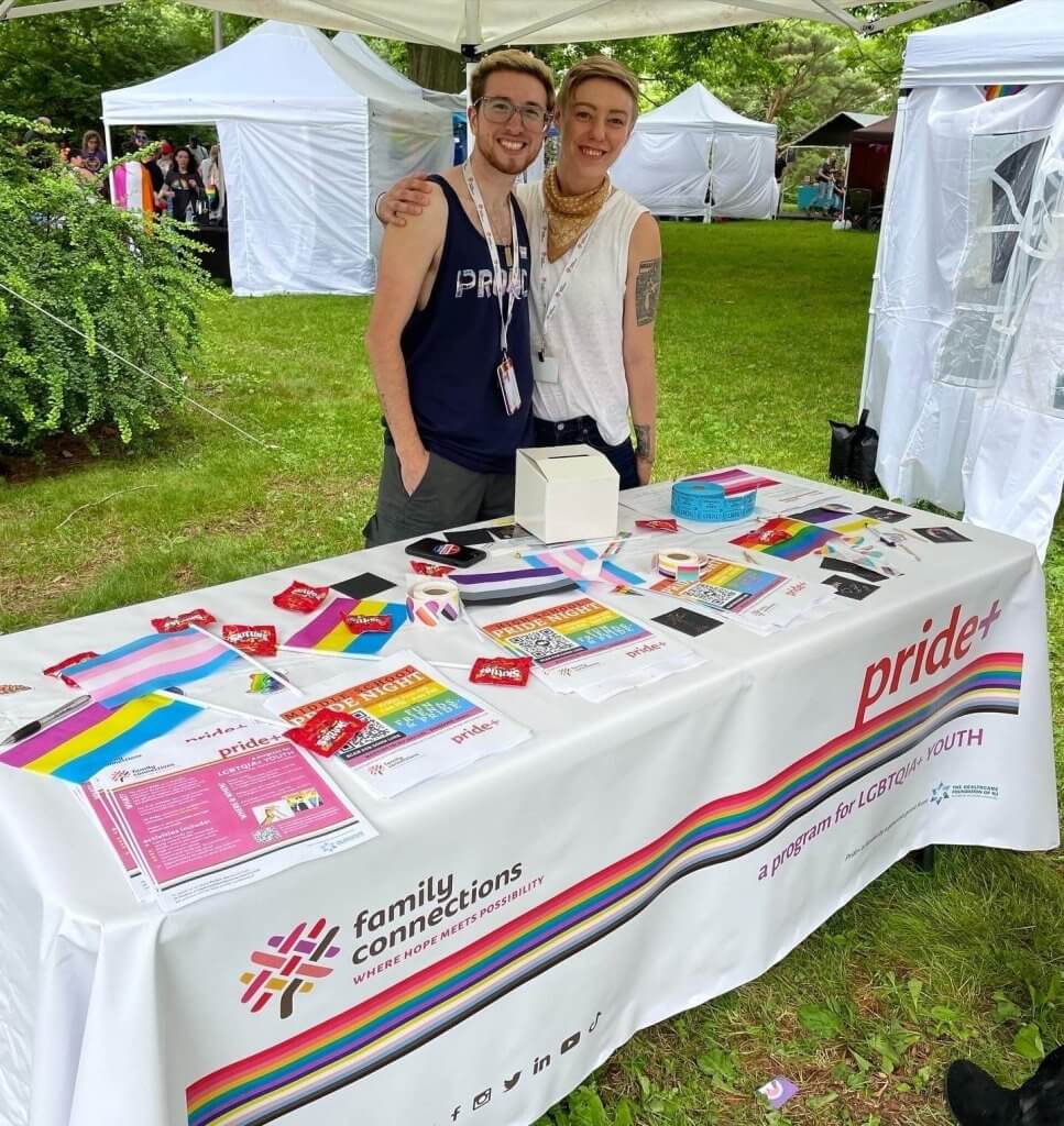 Pride+ Program Coordinator, JP Pedoto, and Pride+ Care Manager, Kels Savage, tabling at Maplewood's Pride Festival in June 2022